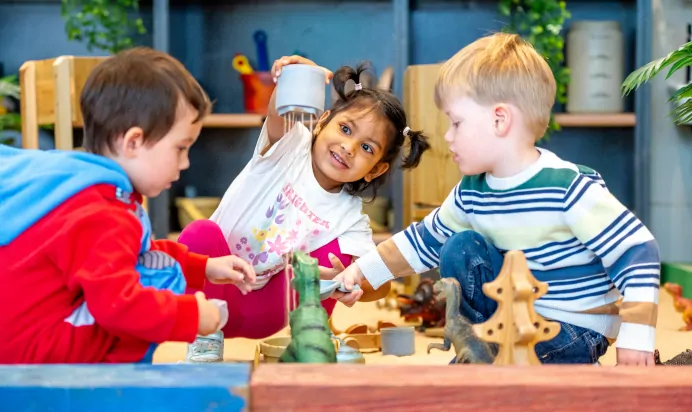 Children playing together in the sand pit at Dicky Birds Nursery Preschool Claremont Road Surbiton