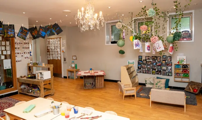Indoor activity area with painting table and book corner at Dicky Birds Nursery Preschool Claremont Road Surbiton