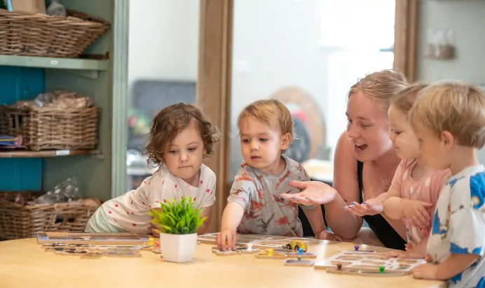 Key worker playing with children at Dicky Birds Nursery Preschool Raynes Park London