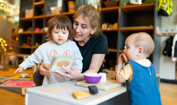 Key worker teaching children fruits at Dicky Birds Nursery Preschool Claremont Road Surbiton