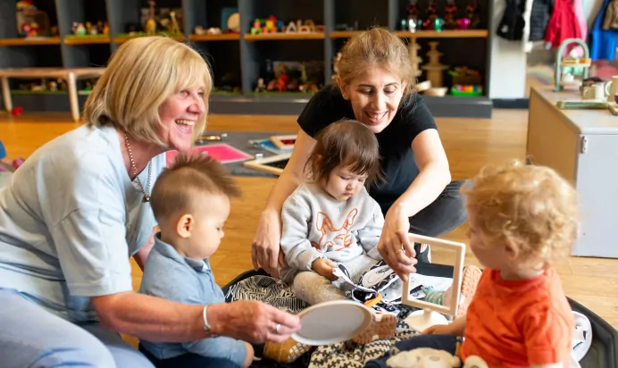 Key workers playing with children at Dicky Birds Nursery Preschool Claremont Road Surbiton