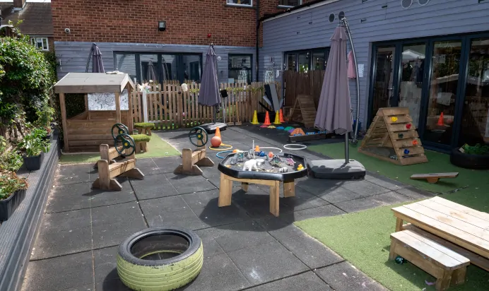 Outdoor play area with sand pit at Dicky Birds Nursery Preschool Raynes Park London