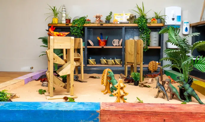 Sand pit with dinosaurs at Dicky Birds Nursery Preschool Claremont Road Surbiton