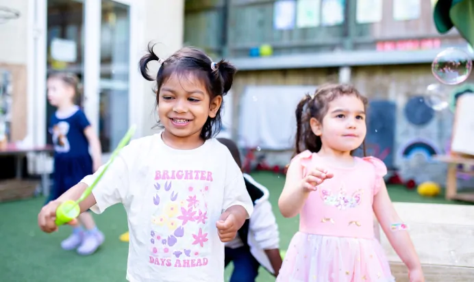 Two children playing with bubbles at Dicky Birds Nursery Preschool Claremont Road Surbiton
