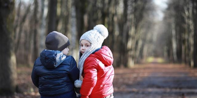 young children outside in a woodland environment