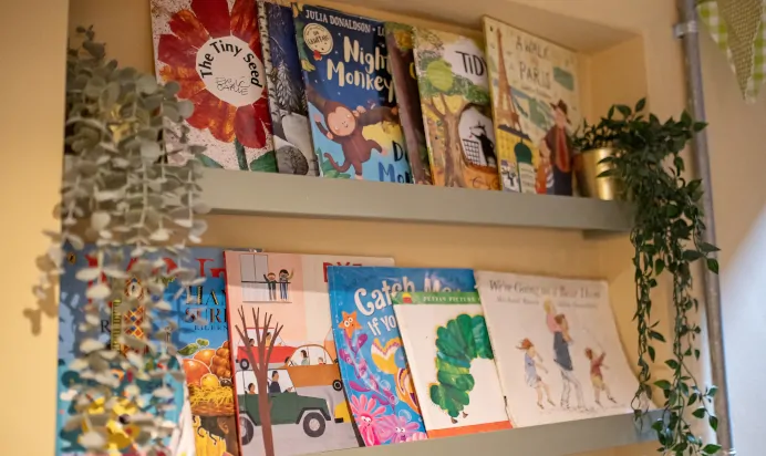 Books displayed across shelf at The Kensington Place Nursery Preschool London
