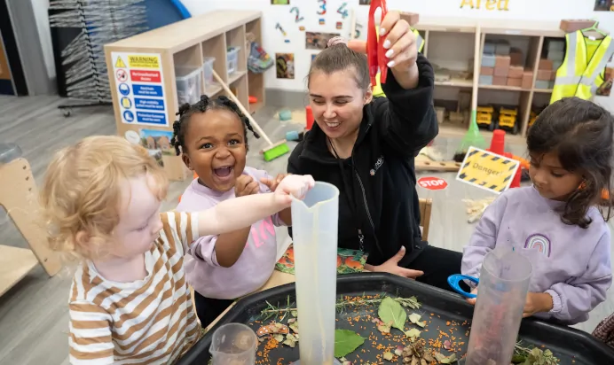 Child and key worker laughing at The Winchmore Hill Day Nursery London