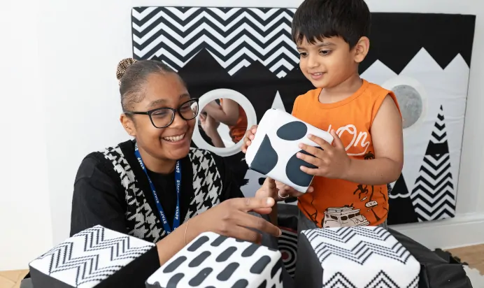 Child and key worker playing with cube toys at Clerkenwell Mount Day Nursery Preschool London