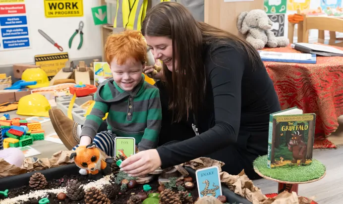 Child and key worker playing with Gruffalo toys at The Winchmore Hill Day Nursery London