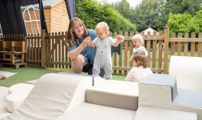 Child climbing on foam blocks at The Daydream Nursery Preschool Woking
