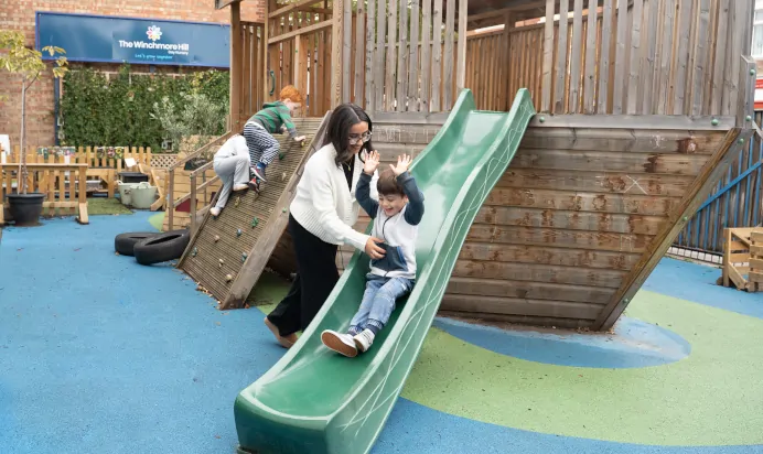 Child going down slide at The Winchmore Hill Day Nursery London