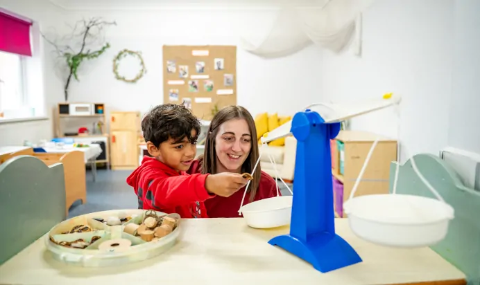 Child playing inside interactive space with key worker at Radcliffe On Trent Day Nursery Preschool