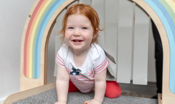 Child smiling in interactive space at The Penge East Day Nursery Preschool London