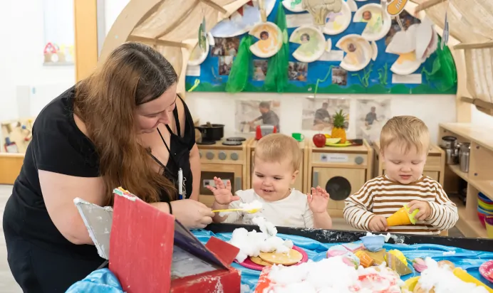 Children and key worker doing arts and crafts at The Winchmore Hill Day Nursery London