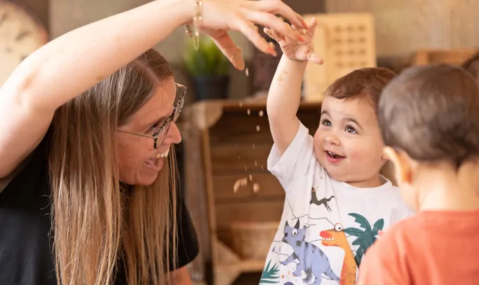 Children and key worker playing with sand at The Chiswick House Day Nursery Preschool London
