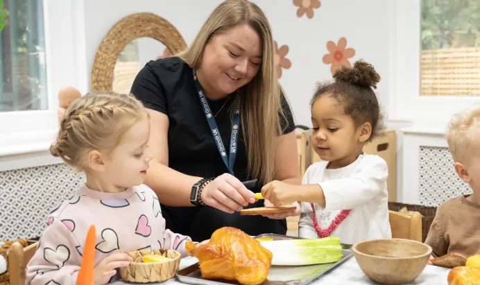 Children learning with key worker at The Chingford Forest Day Nursery Preschool London