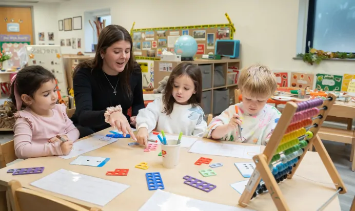 Children learning with key worker at The Winchmore Hill Day Nursery London