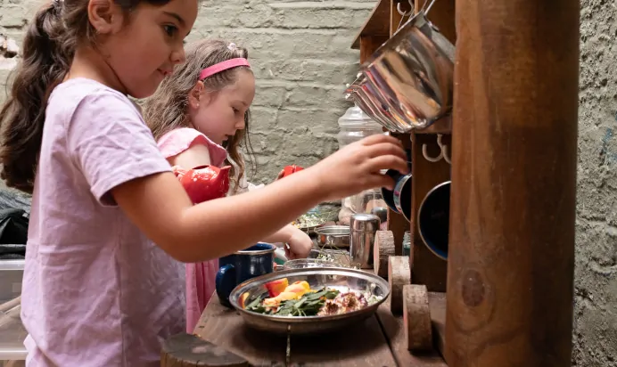 Children playing in kitchen at The Kensington Place Nursery Preschool London