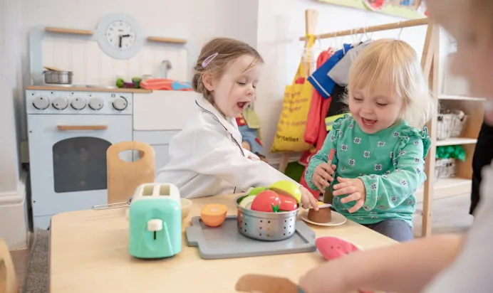 Children playing in kitchen at The Penge East Day Nursery Preschool London