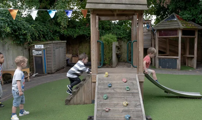 Children playing in outdoor space at The Penge East Day Nursery Preschool London