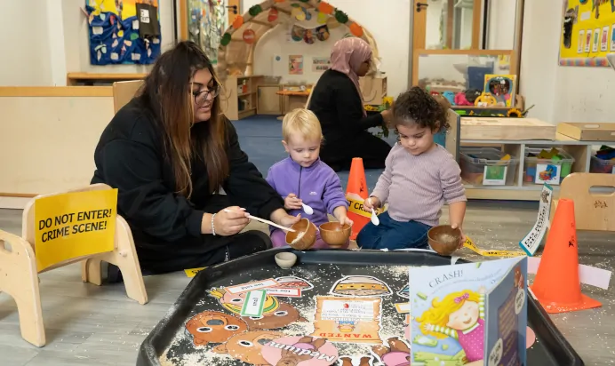 Children playing indoors with key worker at The Winchmore Hill Day Nursery London