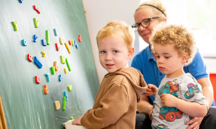 Children playing with a key worker in an interactive space at Radcliffe On Trent Day Nursery Preschool