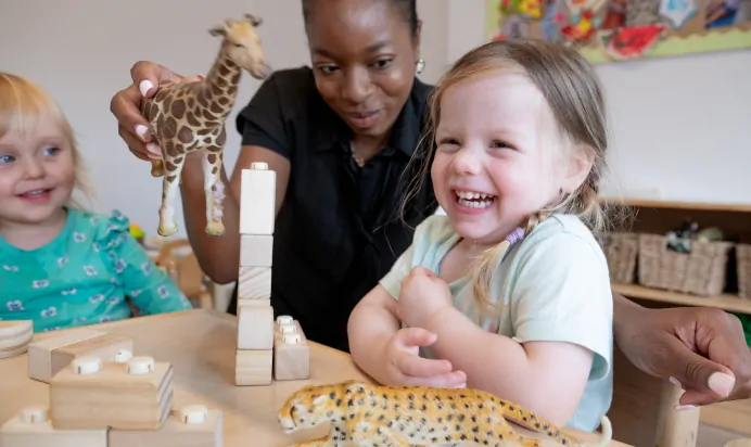 Children playing with animal toys at The Penge East Day Nursery Preschool London