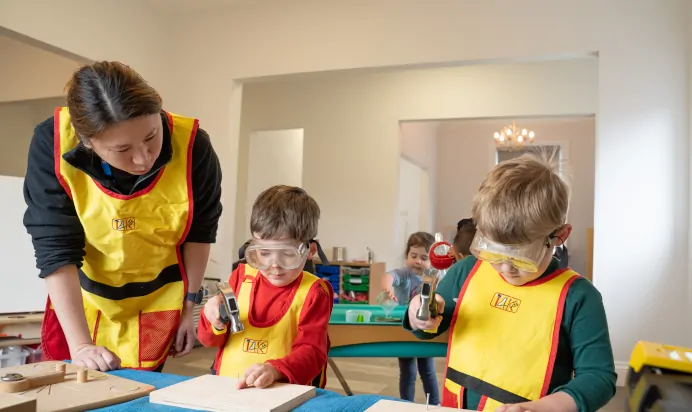 Children playing with diy toy at The Ryan House Day Nursery Preschool Nottingham