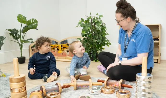 Children playing with key worker at The Chingford Forest Day Nursery Preschool London