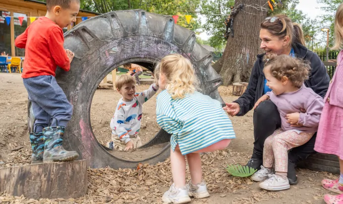 Children smiling to each other at The Chingford Forest Day Nursery Preschool London