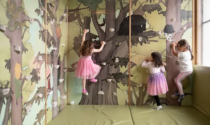 Children using climbing wall at The Chiswick House Day Nursery Preschool London