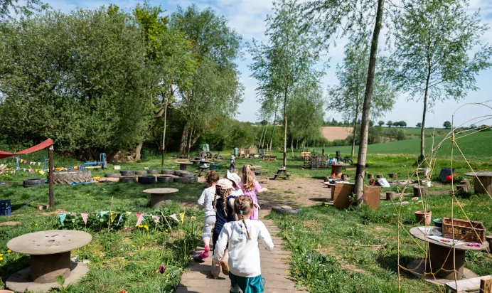 Children walking in a line to play outside at Pippins Montessori Day Nursery Forest School Colchester