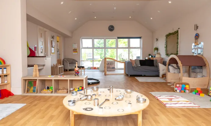 Indoor space with reading area and cooking equiptment at Pippins Montessori Day Nursery Forest School Colchester