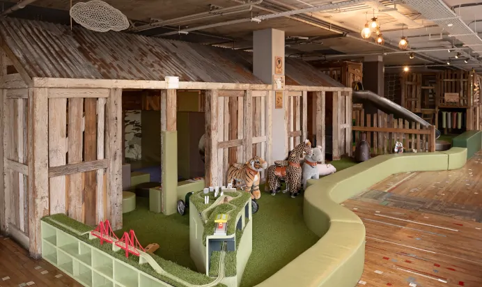 Indoor wooden house play area at The Chiswick House Day Nursery Preschool London