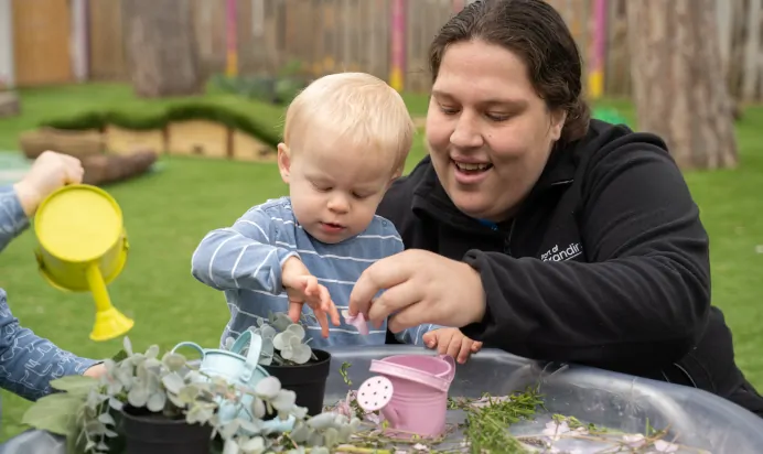 Key worker supporting child at The Chingford Forest Day Nursery Preschool London