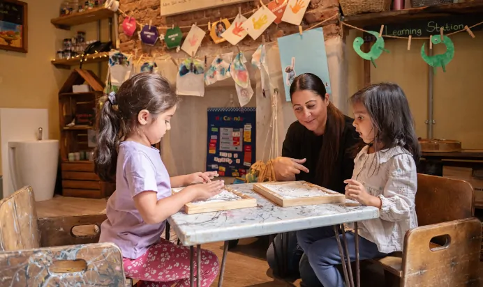 Key worker supporting children at The Kensington Place Nursery Preschool London
