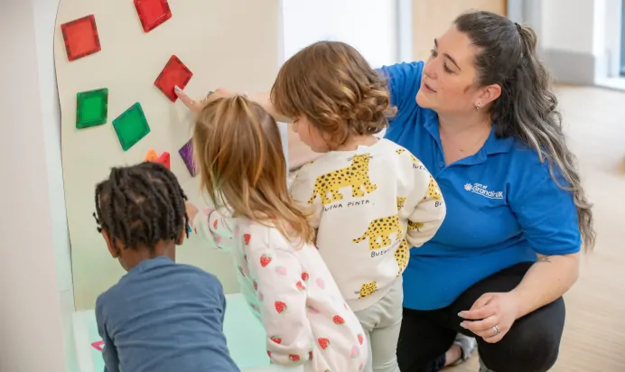 Key worker supporting children at The Wandsworth Day Nursery Preschool London