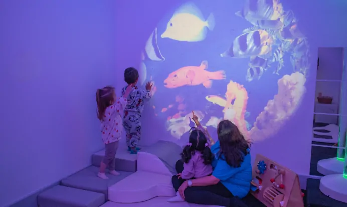 Key worker teaching children about fish at The Wandsworth Day Nursery Preschool London