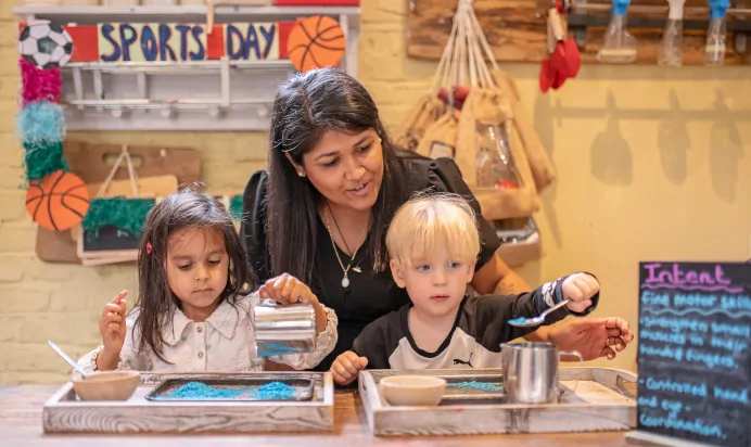 Key worker with children at The Kensington Place Nursery Preschool London