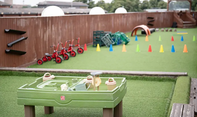Outdoor play area with water pit at The Chiswick House Day Nursery Preschool London