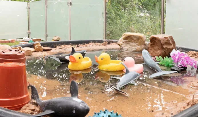 Sand and water pit in bright outdoor space at The West Finchley Day Nursery Preschool London