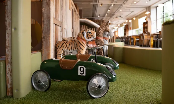 Tiger toy on race car at The Chiswick House Day Nursery Preschool London