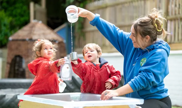 Children and key worker playing with water at The Wishing Tree Nursery Preschool Brighton