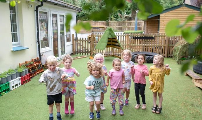 Children jumping outside at The Wishing Tree Nursery Preschool Brighton