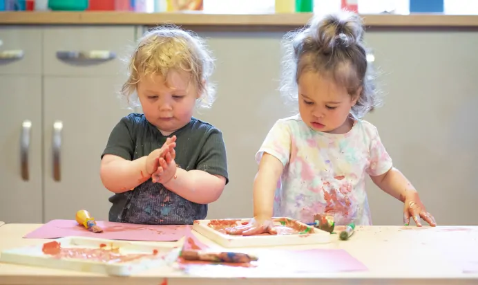 Children playing with paint at The Wishing Tree Nursery Preschool Brighton