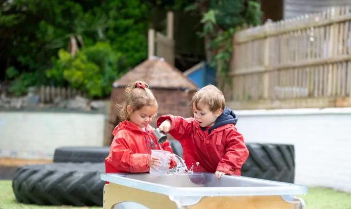 Children playing with water at The Wishing Tree Nursery Preschool Brighton