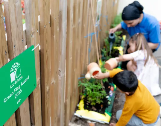 Children outside gardening
