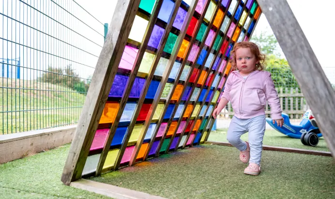 Child playing outside at Kiddi Caru Day Nursery Preschool Brislington Bristol