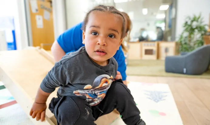Child smiling with key worker at Kiddi Caru Day Nursery Preschool Soundwell Bristol