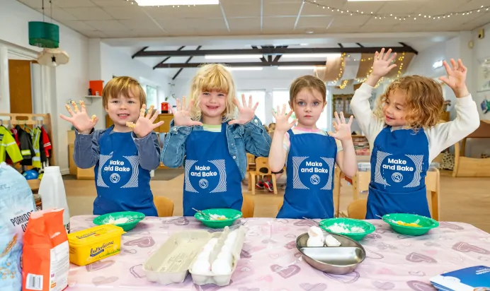 Children showing their hands after baking at Kiddi Caru Day Nursery Preschool Crews Hole Bristol